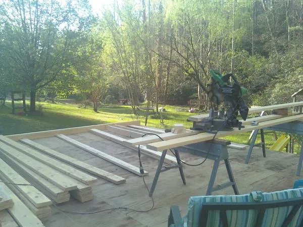 Miter saw and framing lumber on a deck under construction in Lunenburg
